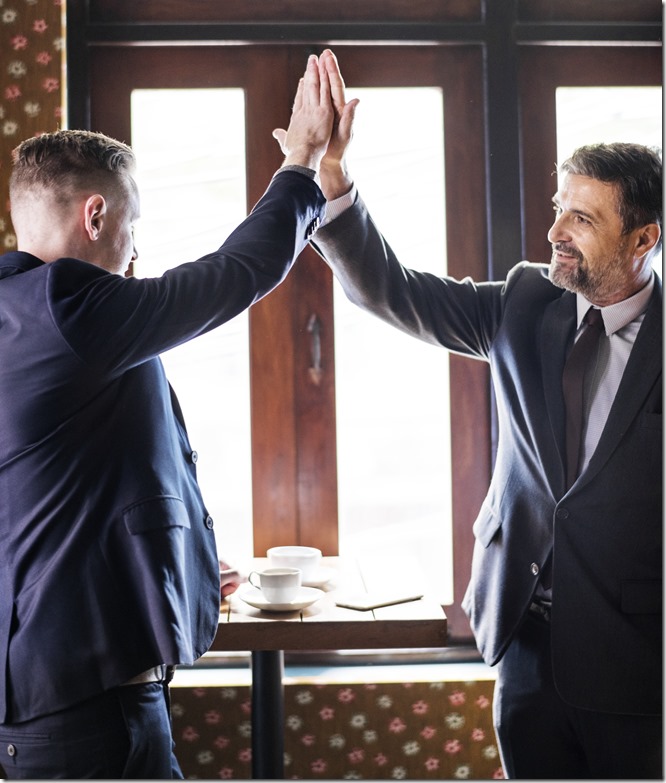 Businessmen giving a high five